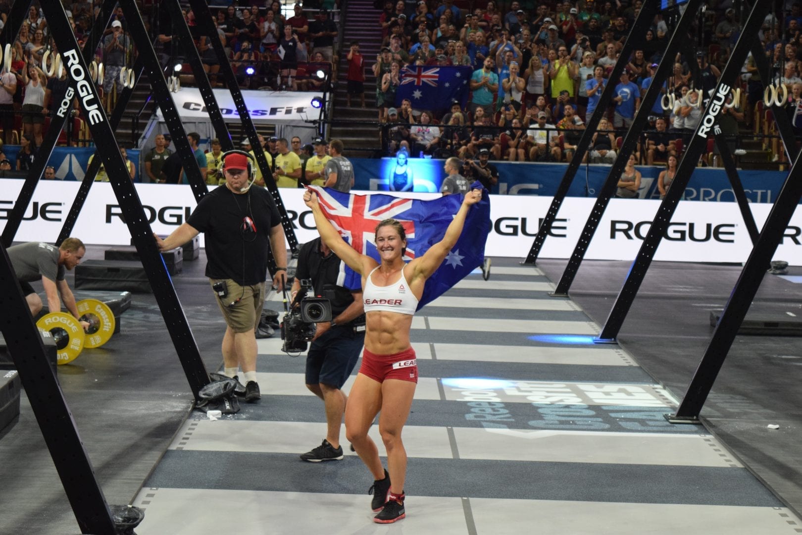 Tia-Clair Toomey of Australia celebrates on the floor of the Coliseum after winning her third-consecutive CrossFit Games