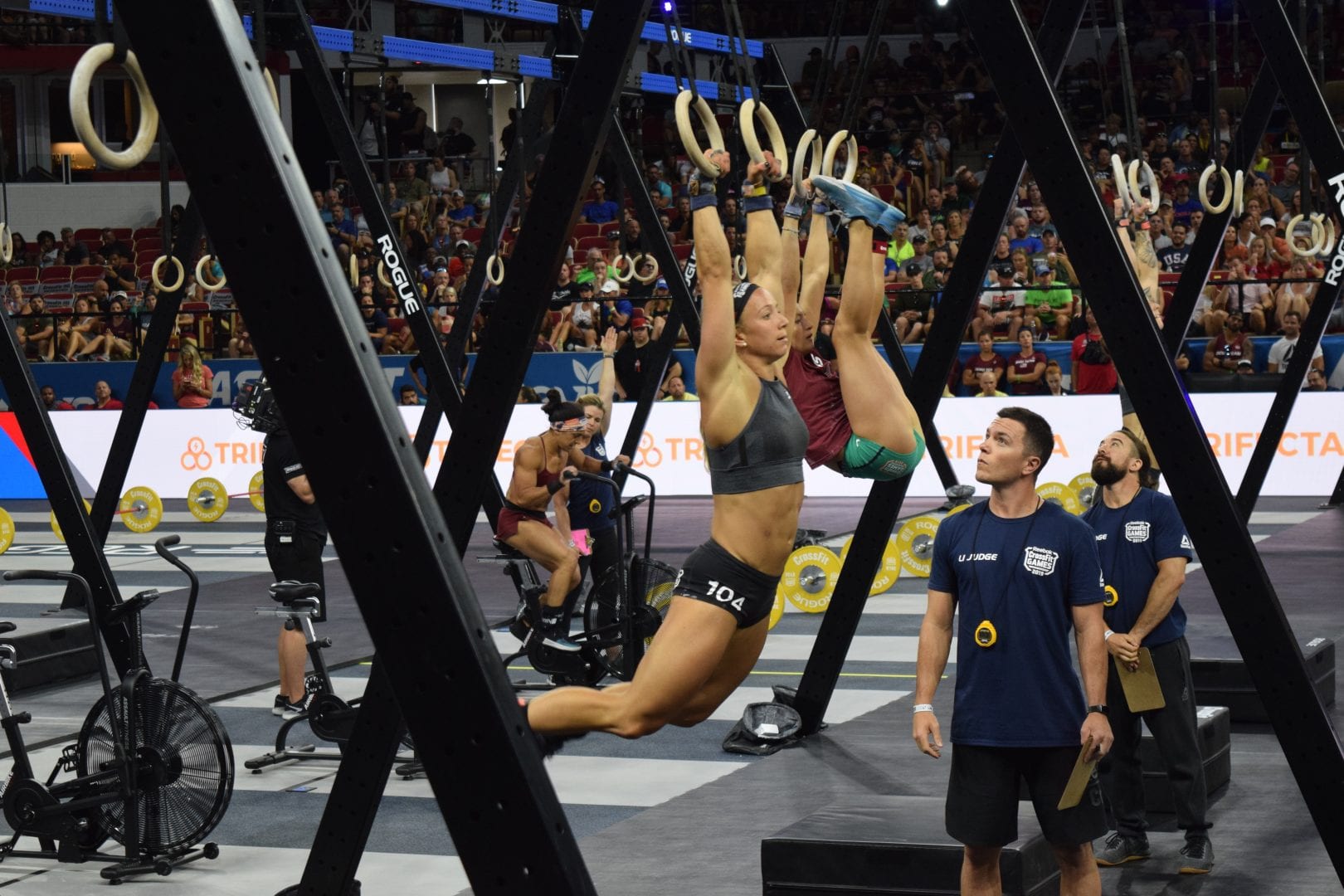 Amanda Barnhart completes toes-to-rings in the Coliseum at the 2019 CrossFit Games.
