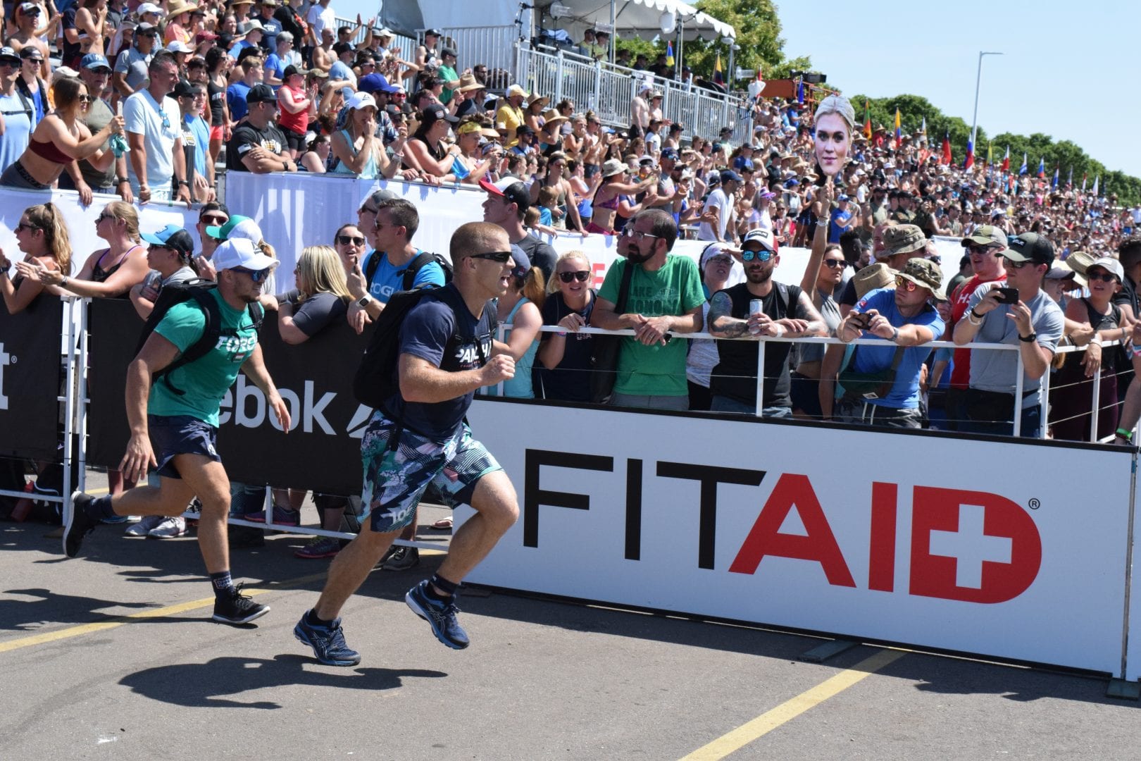Scott Panchik and other athletes complete the Ruck Run event at the 2019 CrossFit Games