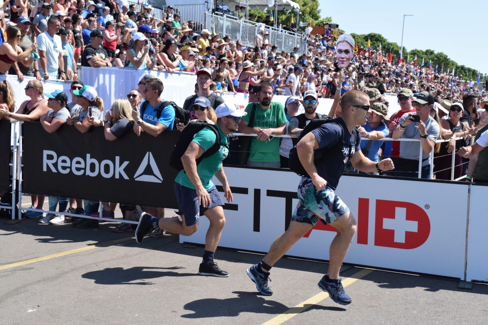 Scott Panchik and other athletes complete the Ruck Run event at the 2019 CrossFit Games