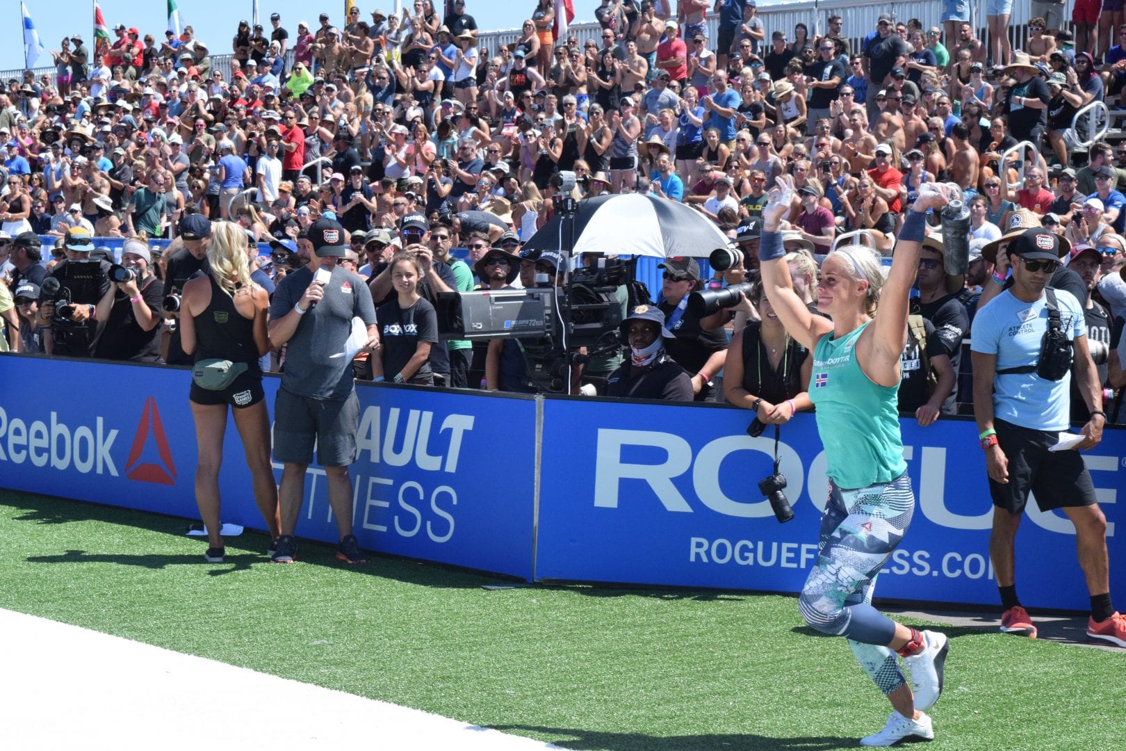 Sara Sigmundsdottir waves at the crowd as she enters the stadium for the first event of the 2019 CrossFit Games