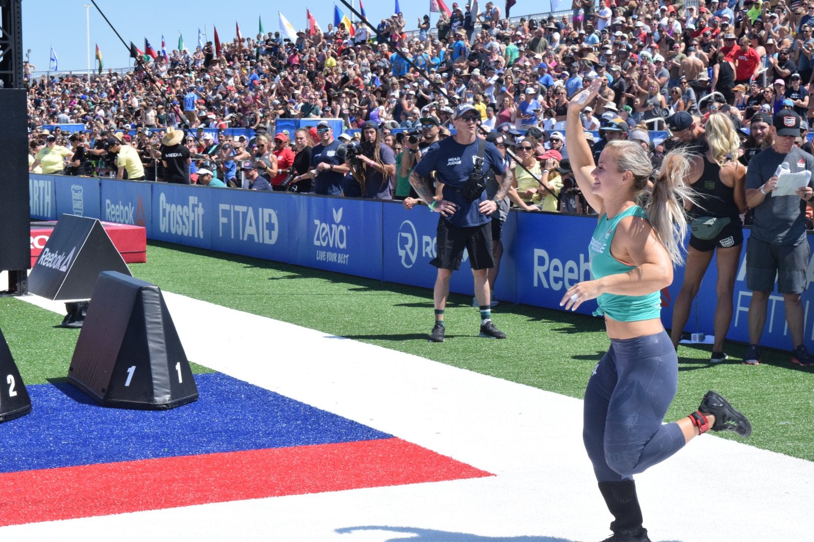 Dani Speegle enters the outdoor stadium of the 2019 CrossFit Games. She'll be competing in the second season of The Titan Games.