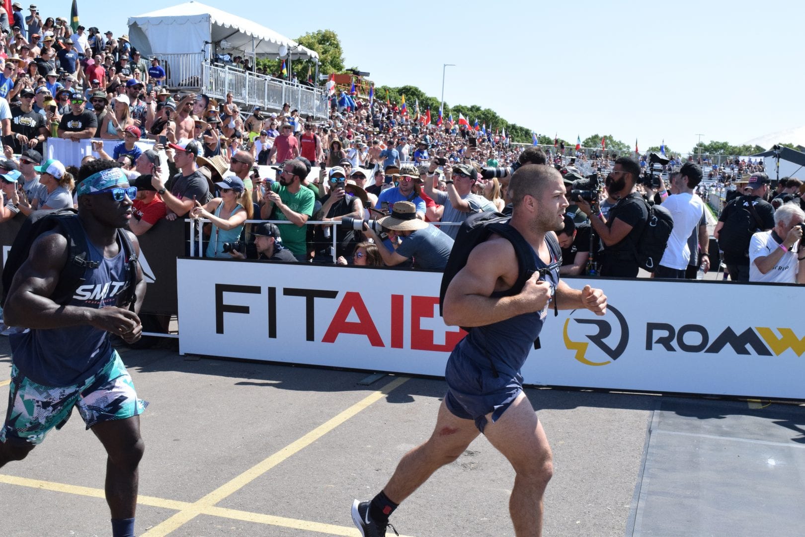 Chandler Smith chases down Jacob Heppner in the Ruck Run event at the 2019 CrossFit Games.
