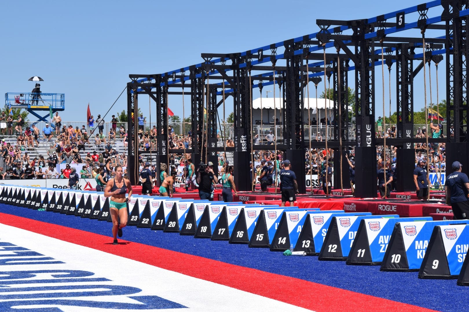 Emily Rolfe takes a lap between rounds of legless rope climbs at the 2019 CrossFit Games