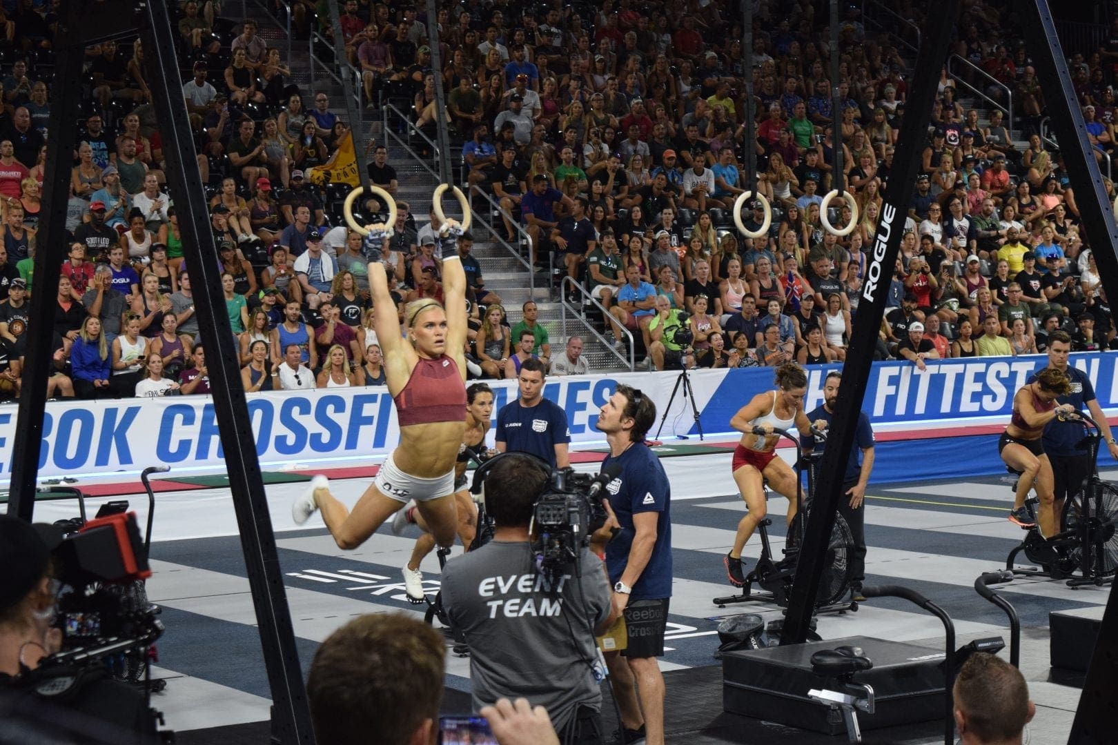 Katrin Davidsdottir on rings in the coliseum completing toes-to-rings in the 2019 CrossFit Games.