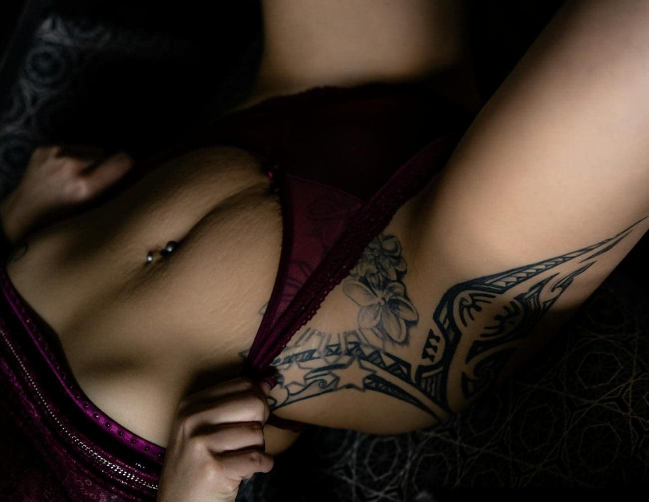 sexy tattooed woman pulling panties